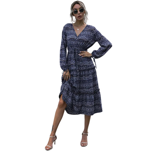 Women's V neck pleated midi dress with long sleeves.