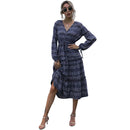 Women's V neck pleated midi dress with long sleeves.